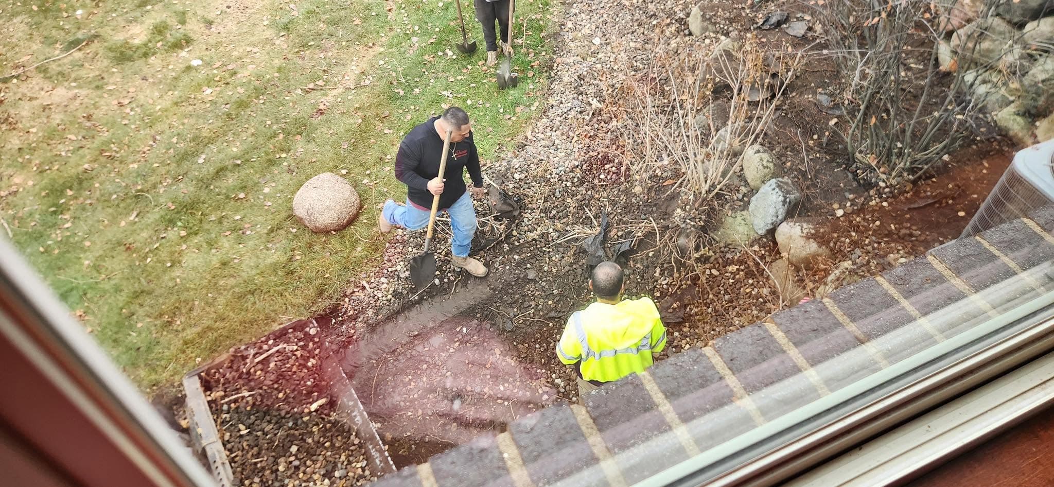 The crew laying out a rock bed, overhead view