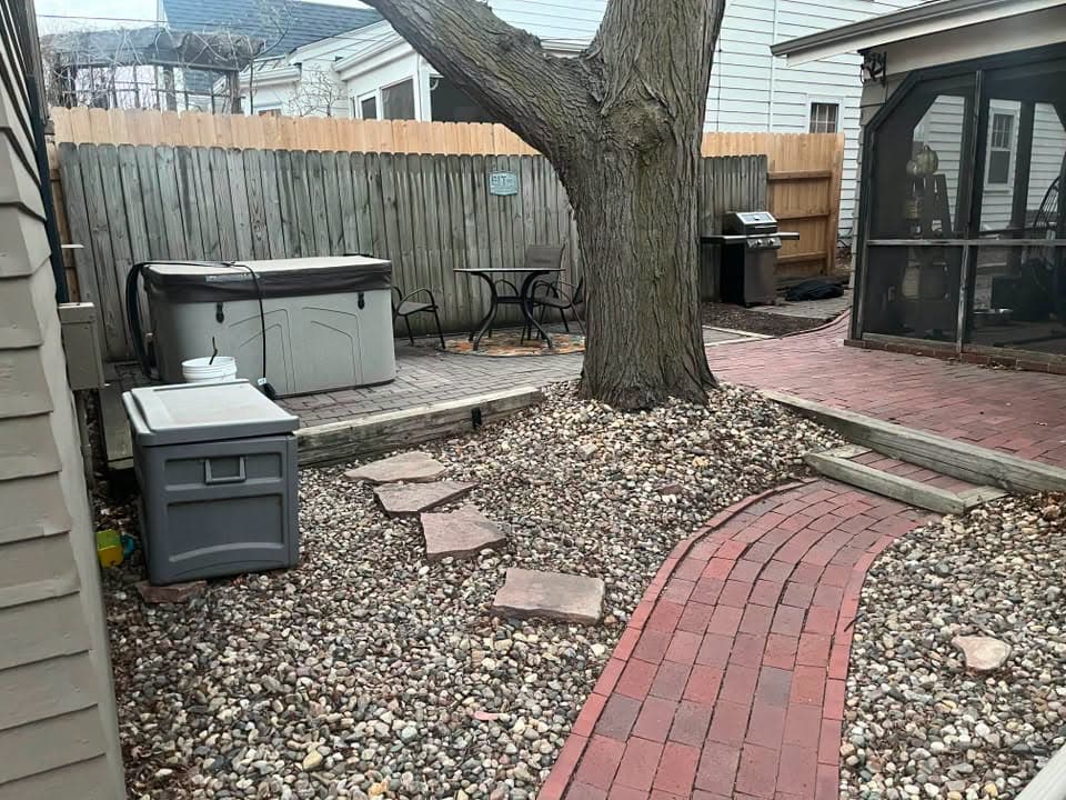 Red paver path leading to a hot tub