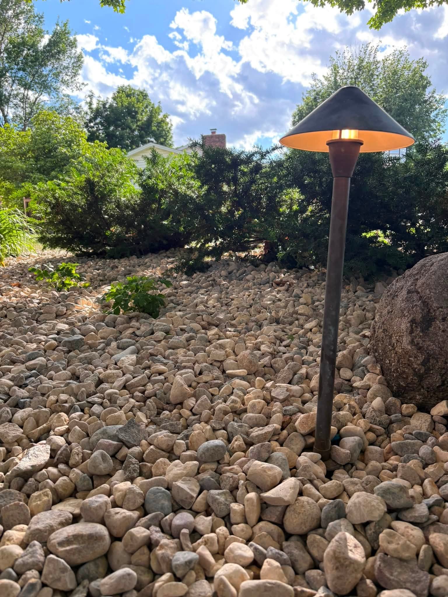 Landscape light fixture set in a rock bed