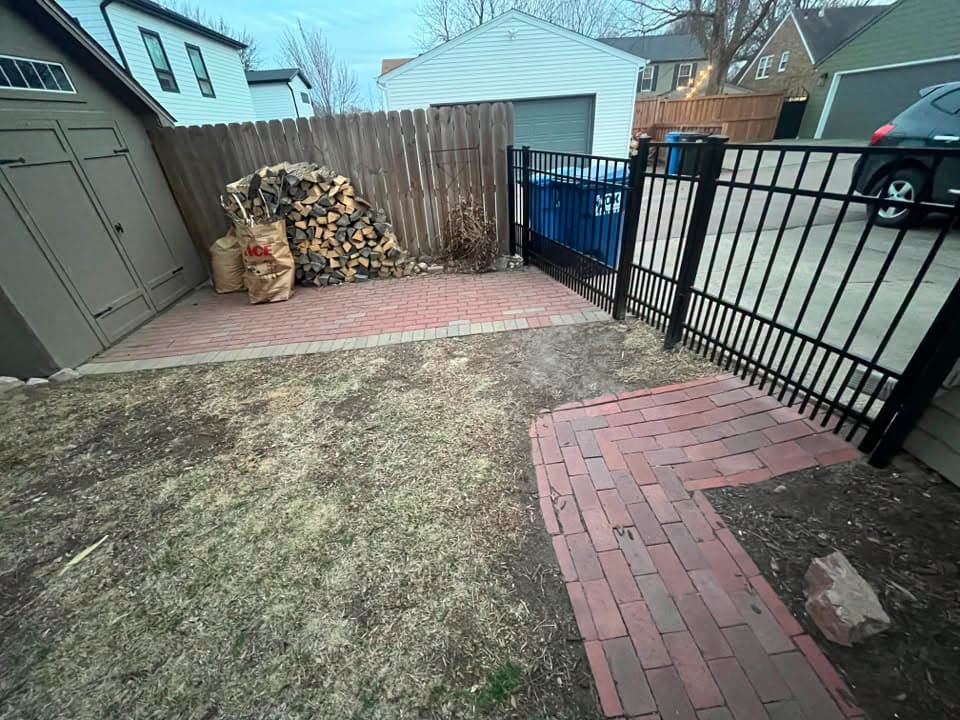 Paver path leading to a fence gate