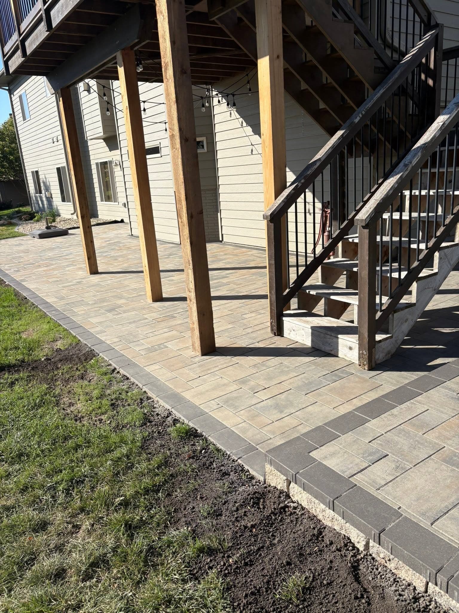 Paver walkway at the base of deck stairs