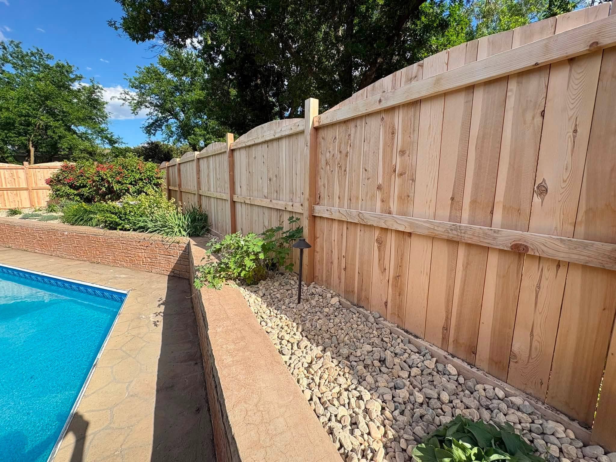 Rock border along a pool fence