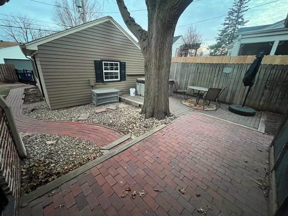Red brick paver patio with outdoor furniture