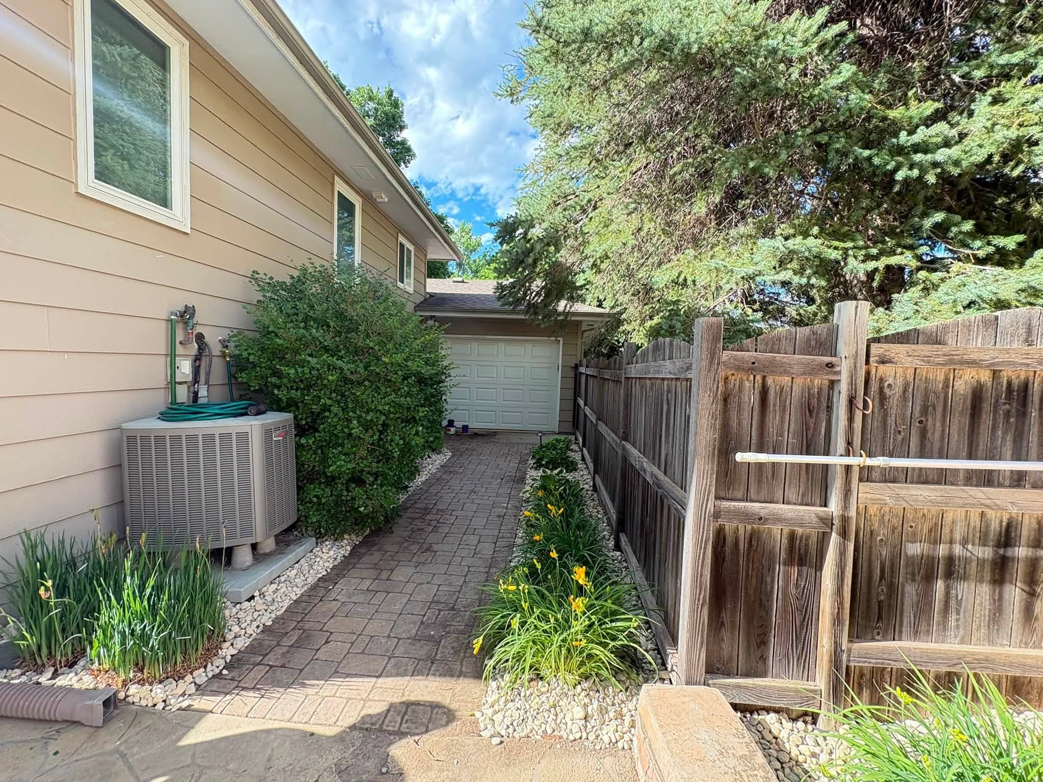 Side yard pavers laid along the utility strip