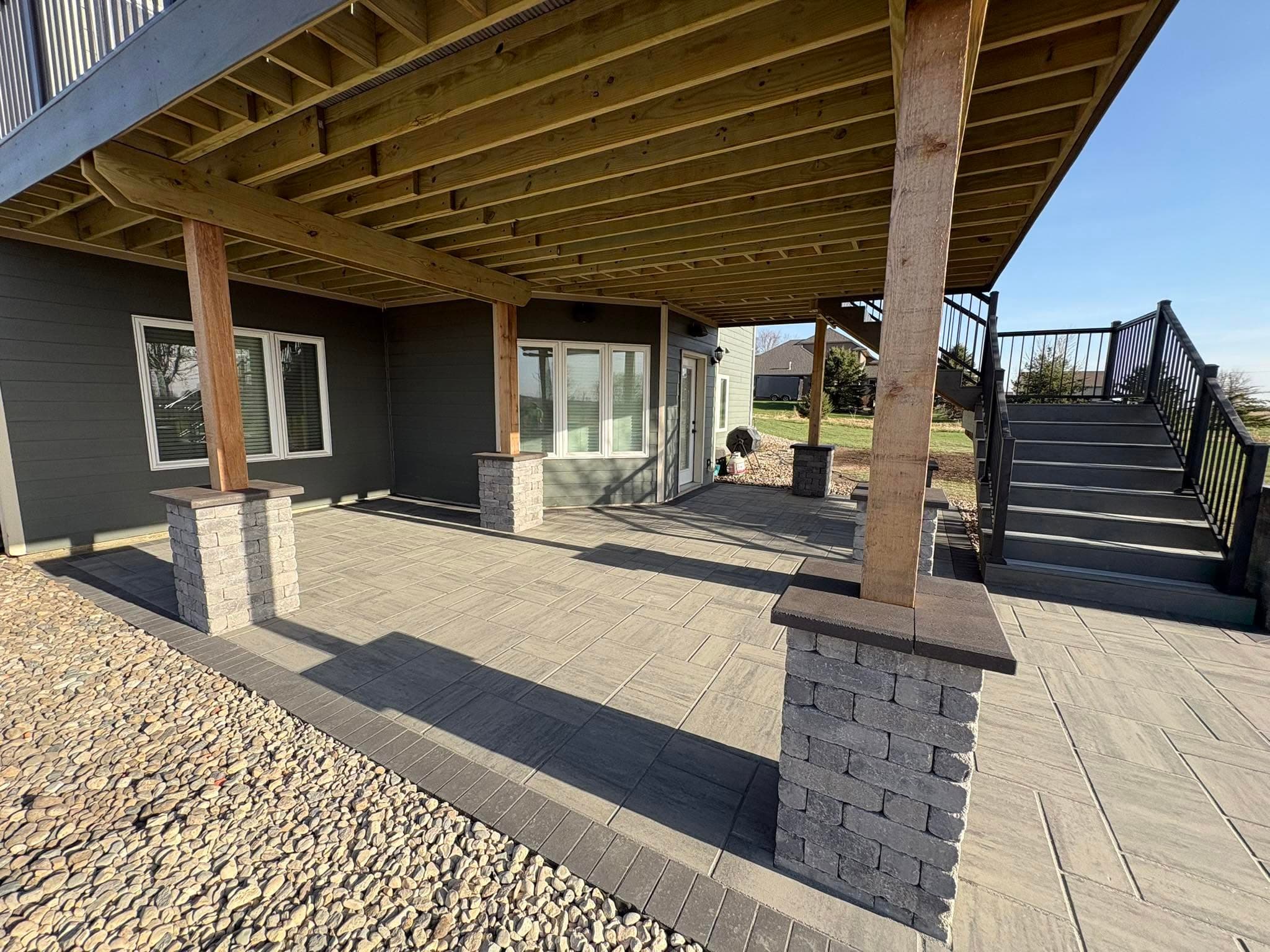 Under deck patio with pillars and rock beds