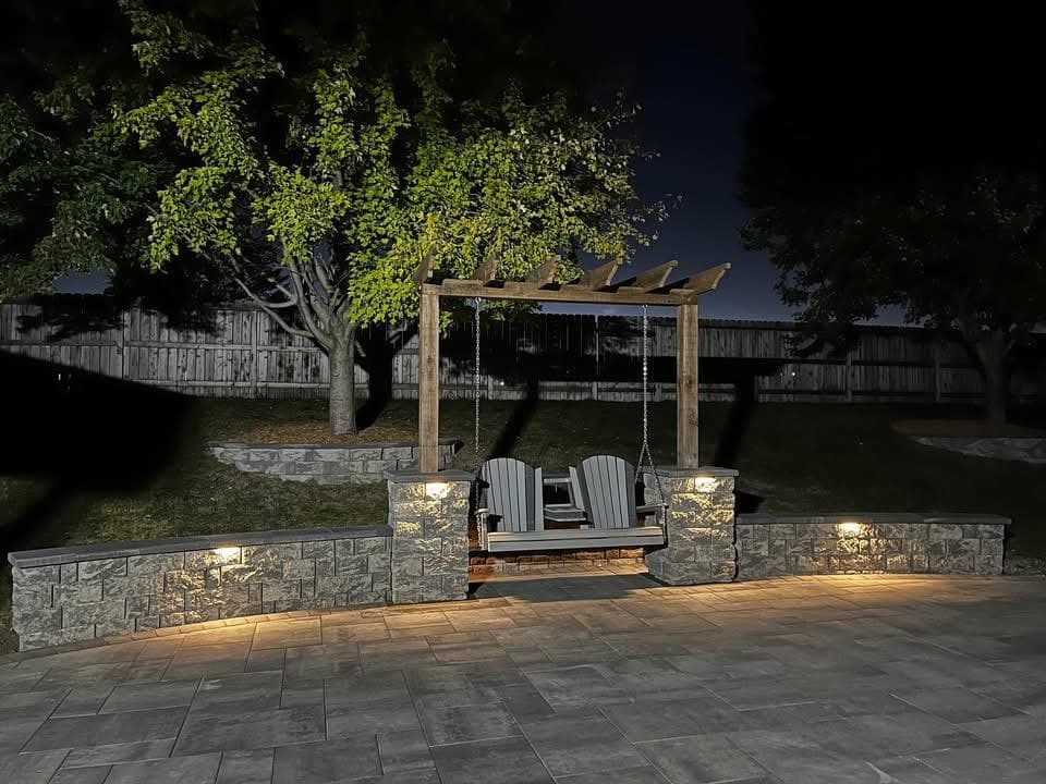 Pergola and landscape lighting glowing at night, from the Ramos Facebook page