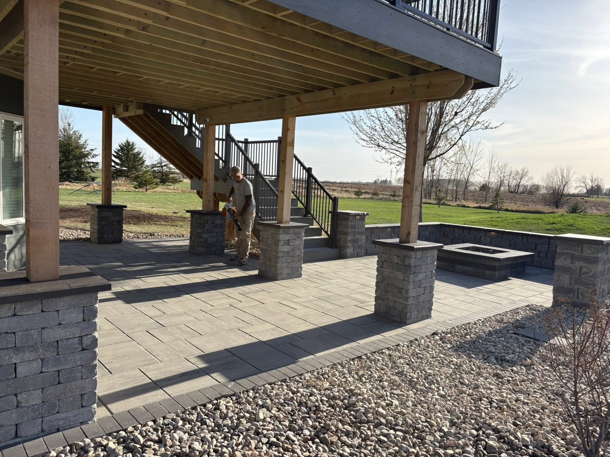 Under deck paver patio with block walls and stone pillars
